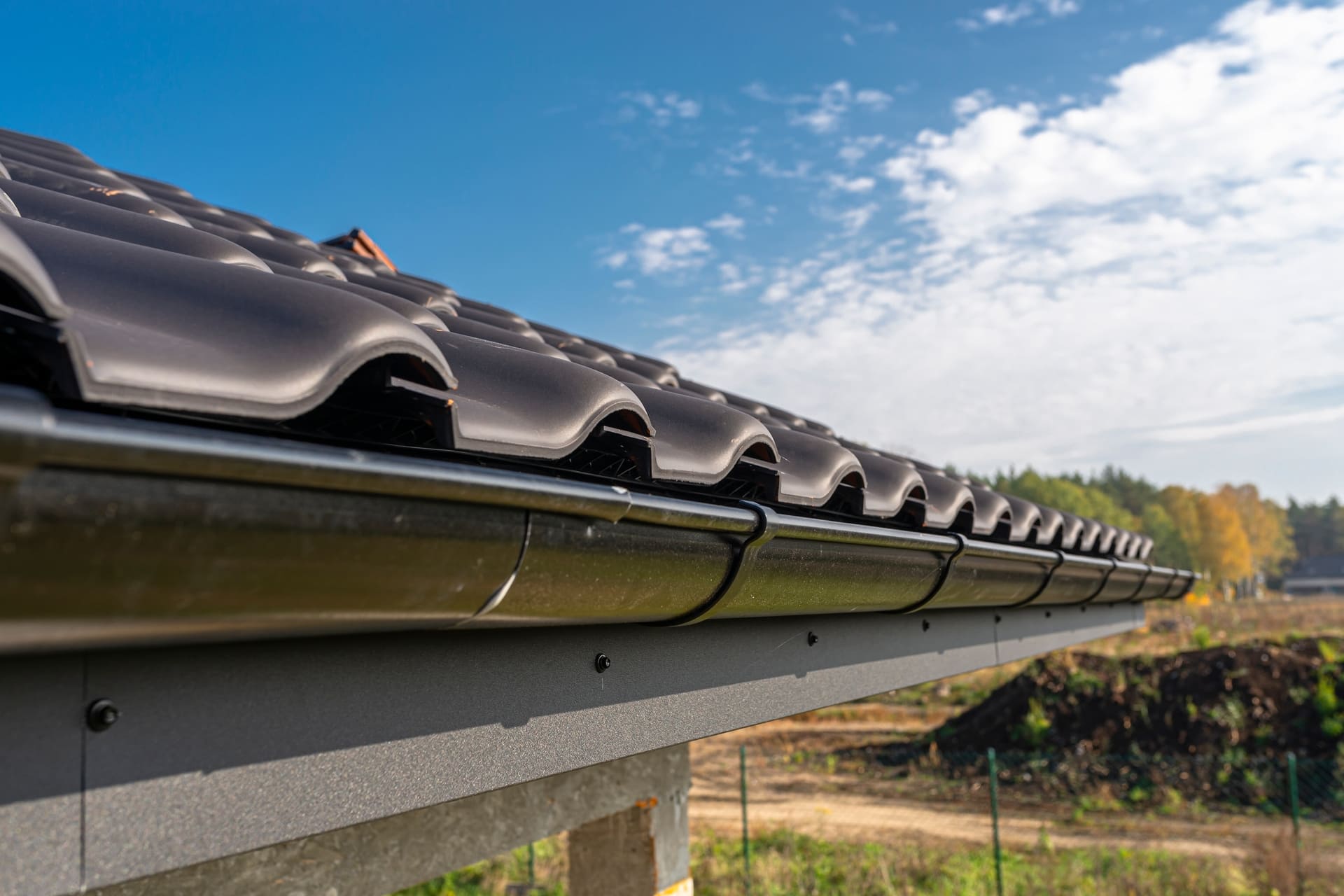 a metal black gutter on a roof