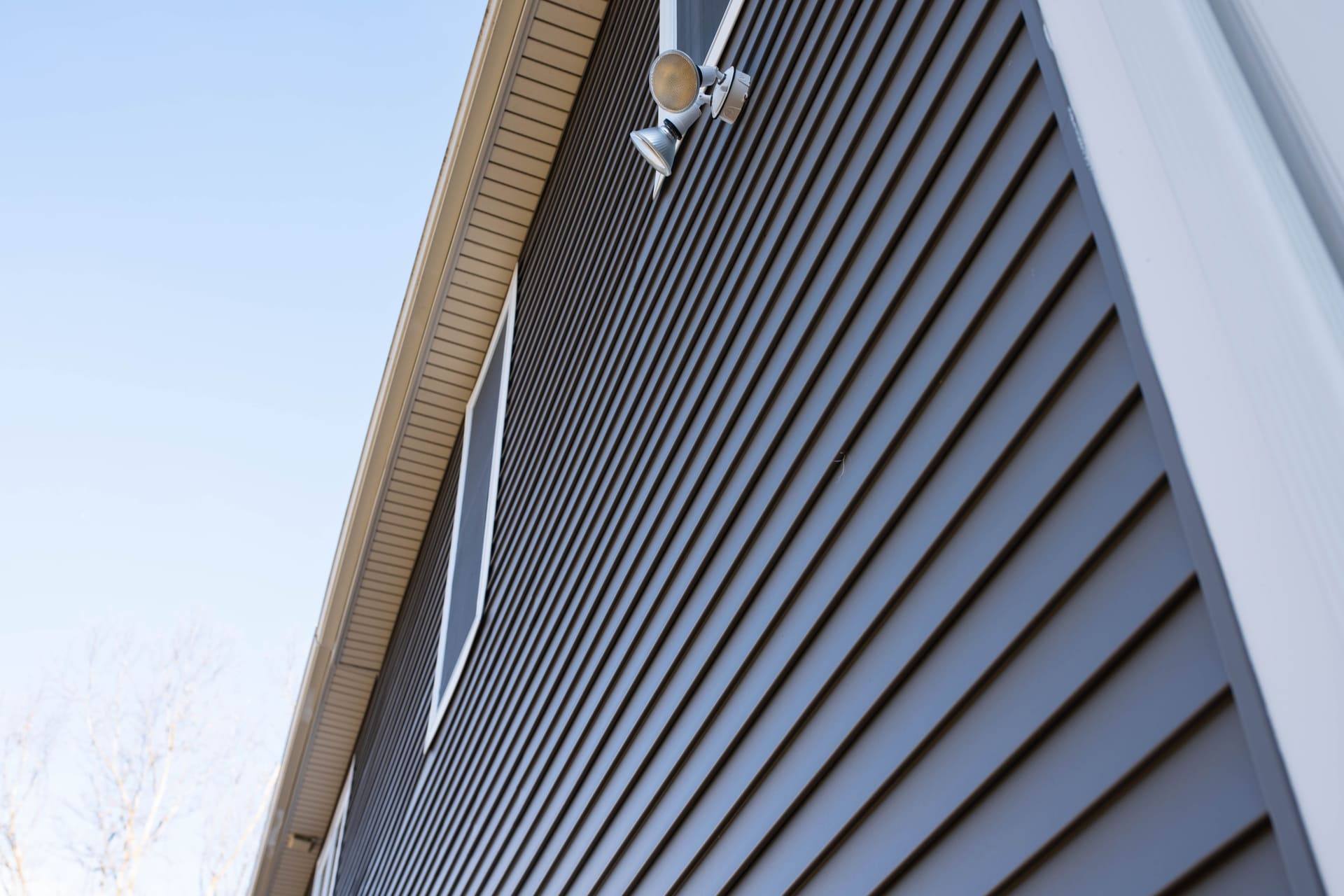 blue-vinyl-siding-wall-of-a-residential-home-under-clear-sky